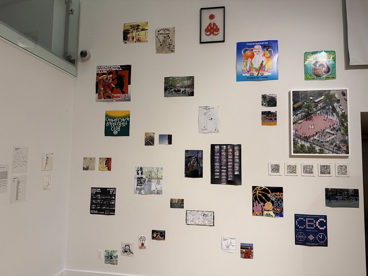 A gallery wall featuring posters, photographs, and other print ephemera hung salon style. 