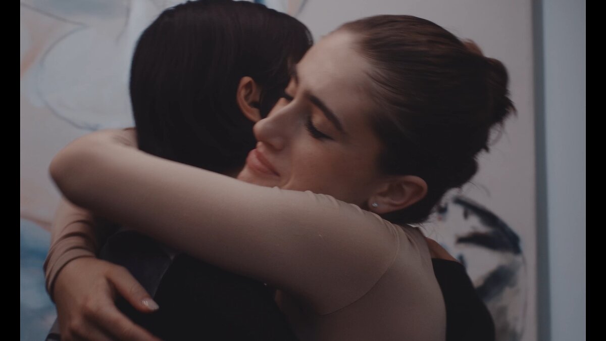 Two women embrace in a hug.