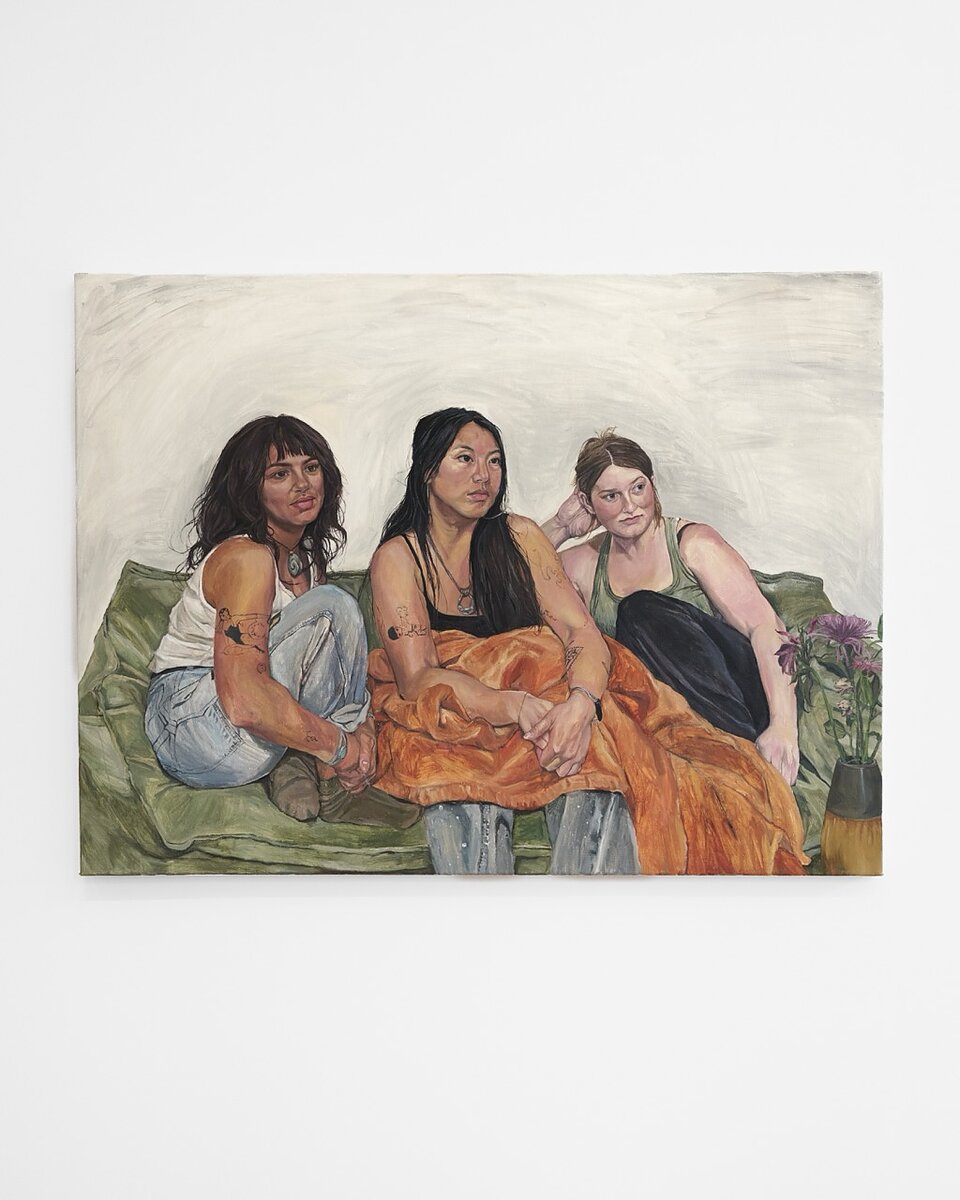 A painting of three young women on a couch looking at something outside of frame.