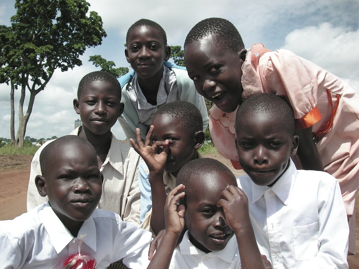 A crowd of children poses outside.