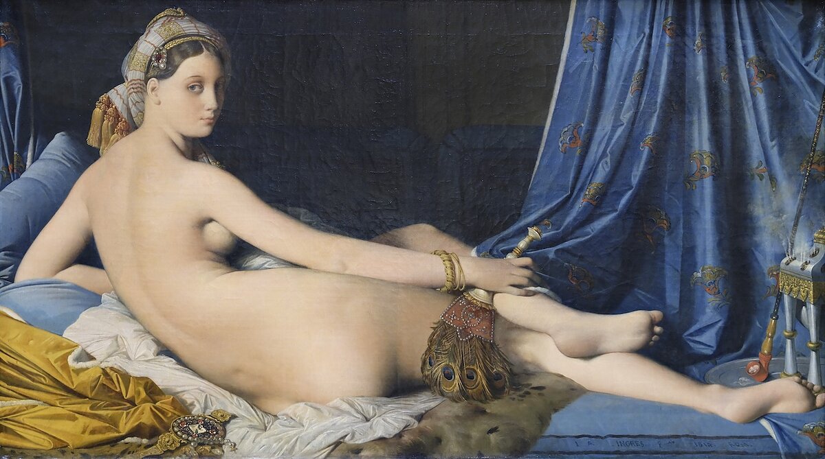 A painting of a nude reclined woman from behind looking back at us while holding a duster of ostrich feathers and surrounded by lush blue and gold fabrics and decorative objects.