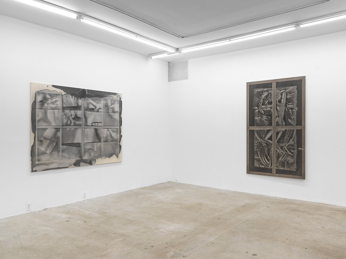 An installation shot of a gallery space featuring two gray scale paintings. 