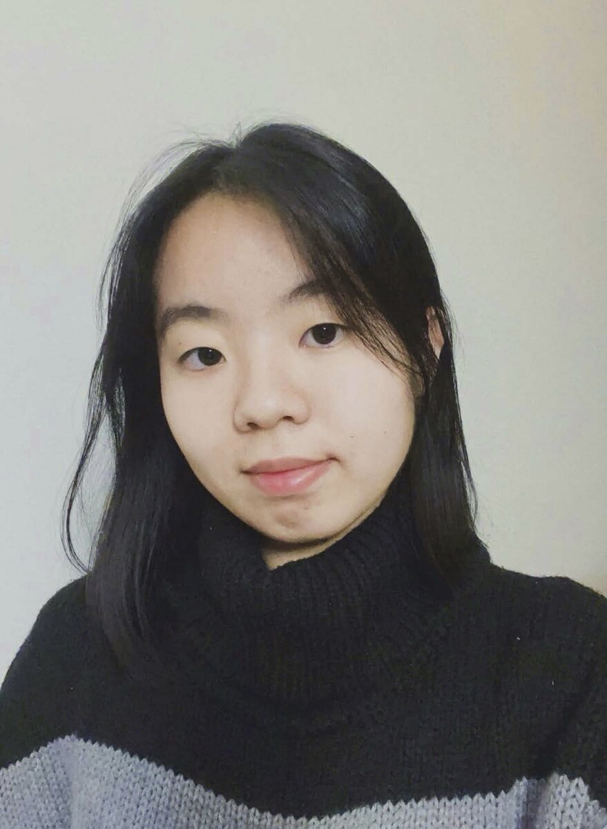 a photo of an Asian woman with long black hair and a black turtleneck sweater against a white background